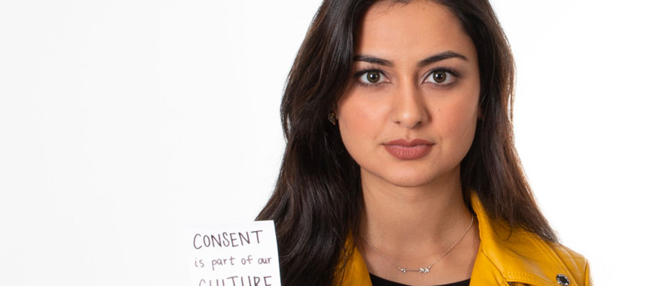 Person holding a post-it that reads "Consent is part of our culture"