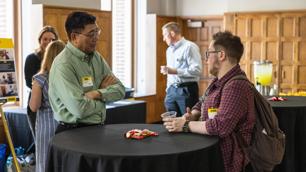 image from the AVC poster session, two people conversing